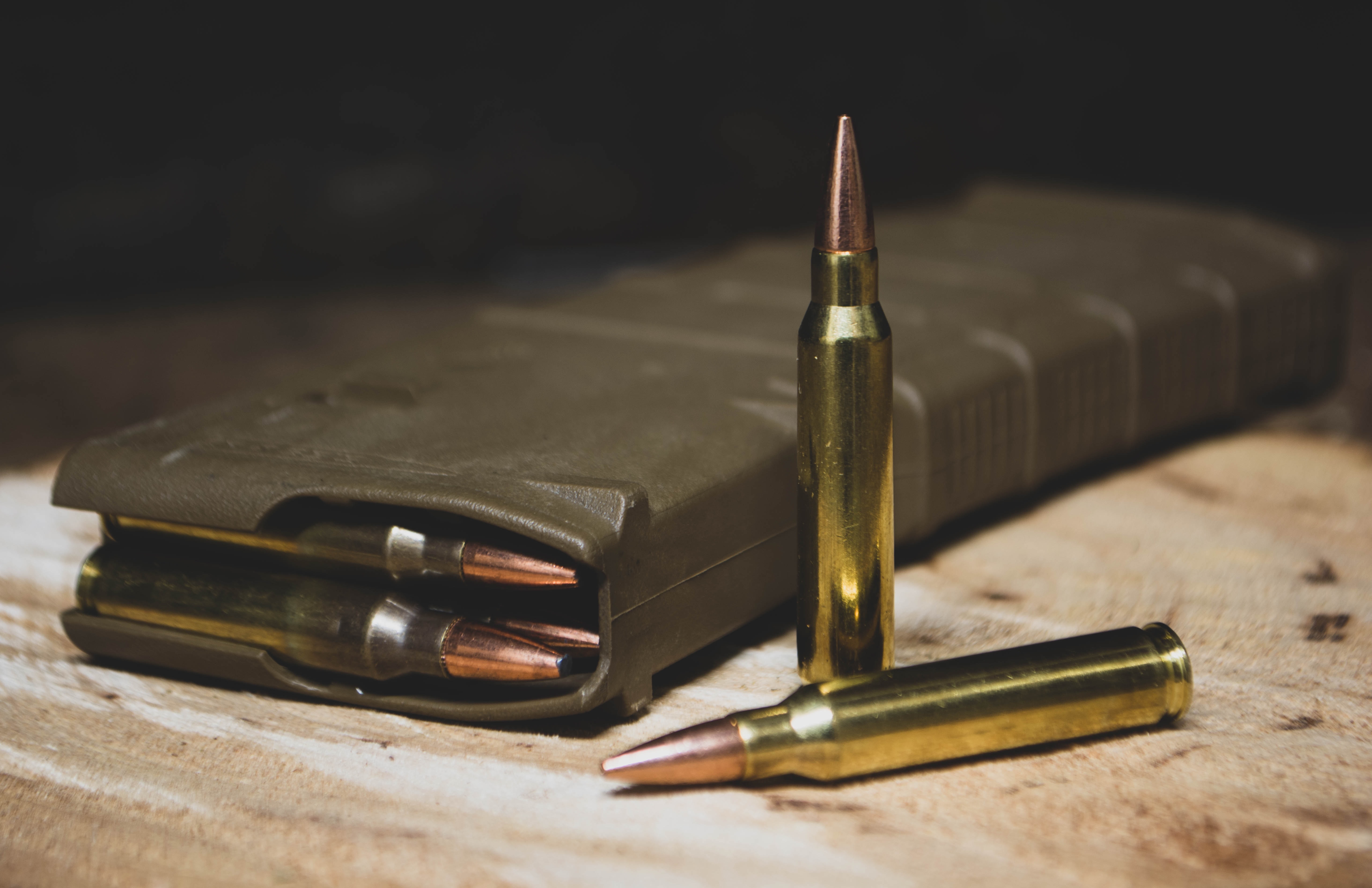 Brass colored bullets outside magazine